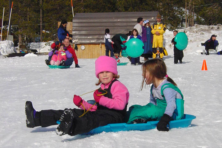 Vintage photo of children sledding at Snowplay